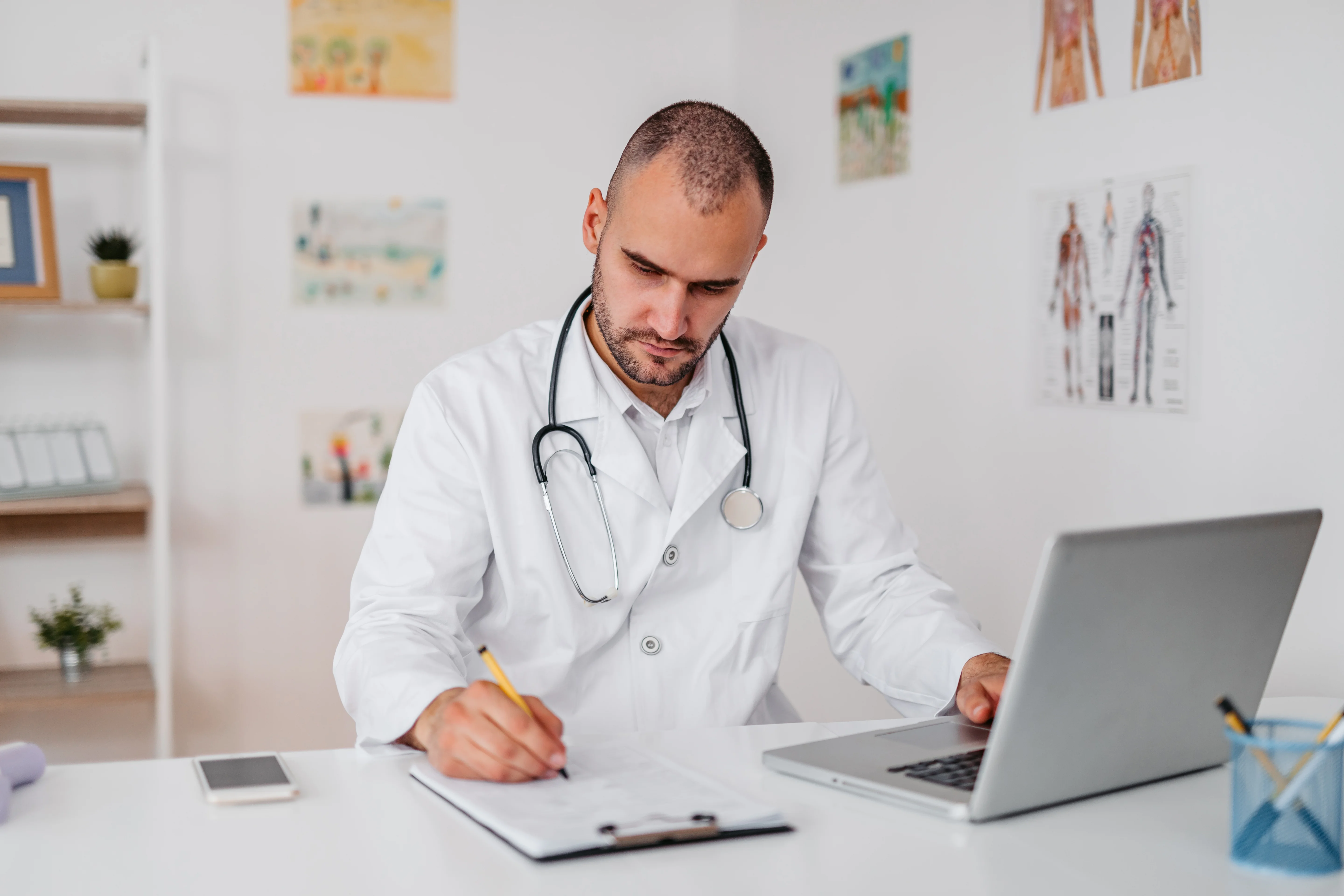 A young doctor checking the medical records in his office.