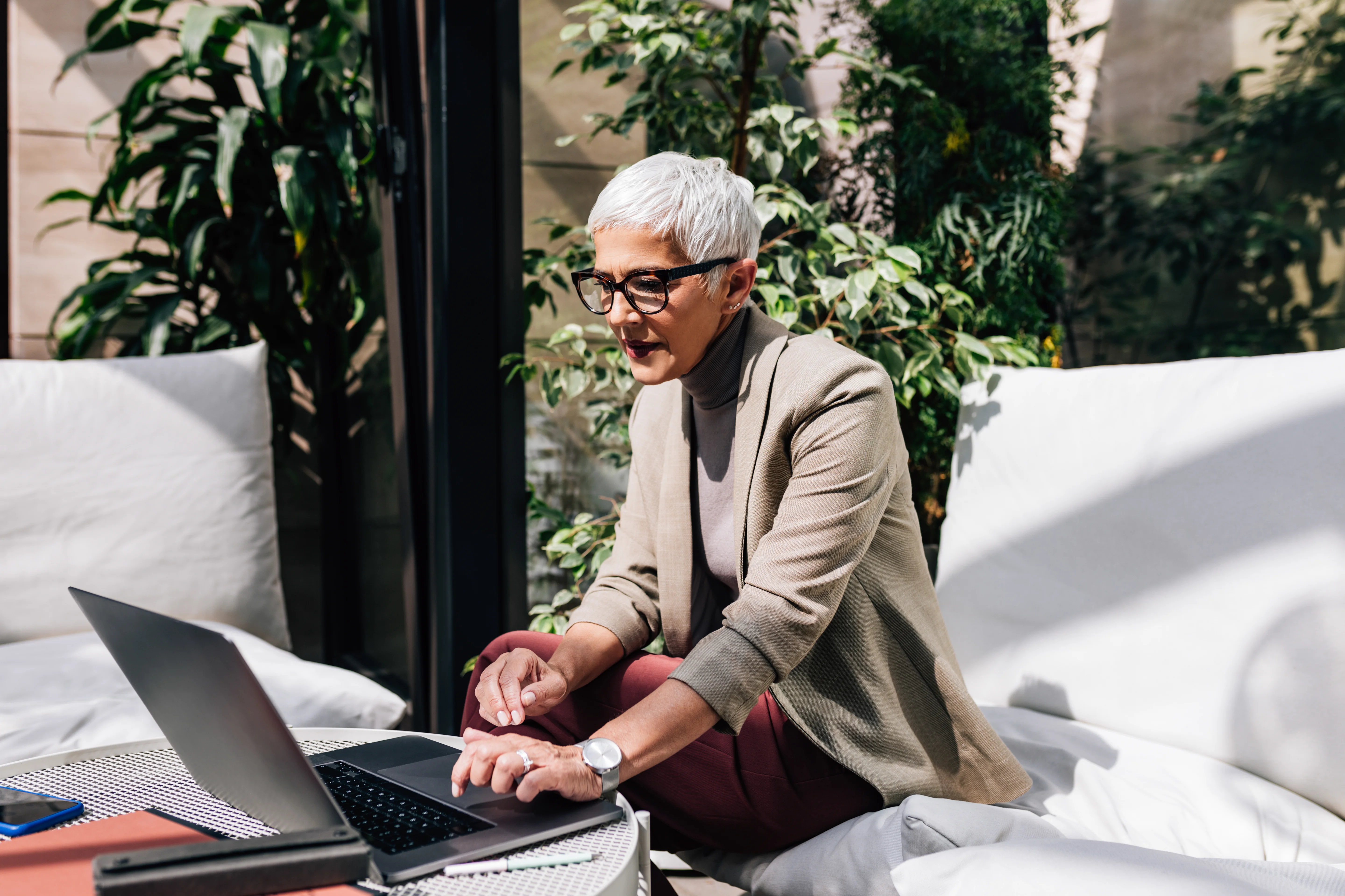 A beautiful senior businesswoman with short gray hair using her laptop computer at work.